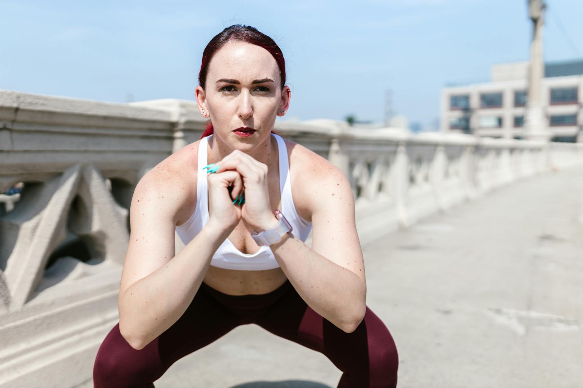Woman in activewear performing a workout on an urban bridge, showcasing fitness and strength. - 30 minute workout