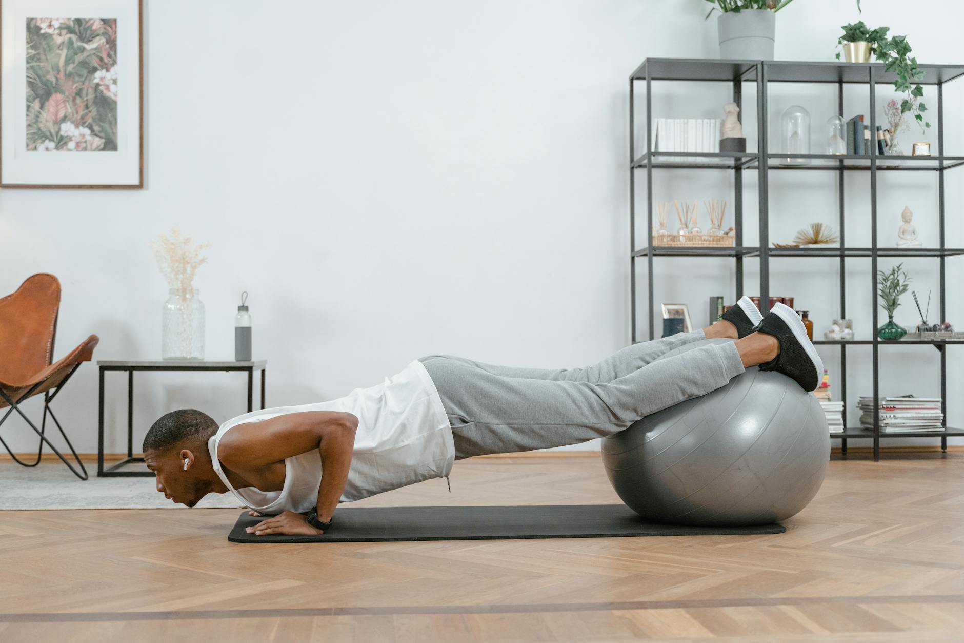 Adult doing push-ups with an exercise ball indoors for fitness and health. - 30 minute workout