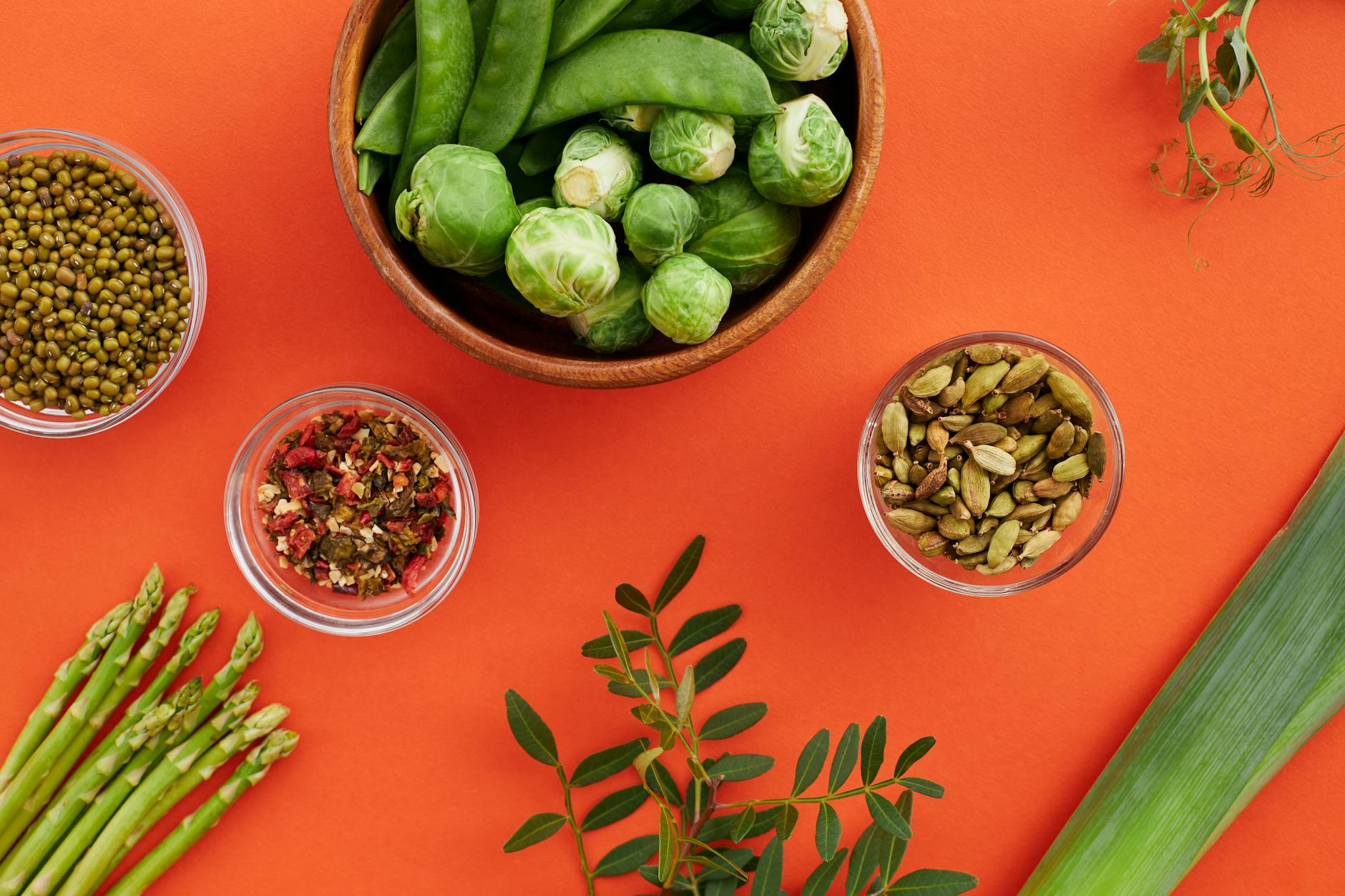 Vibrant display of nutritious vegetables and spices on a bold red background. - anti-inflammatory foods