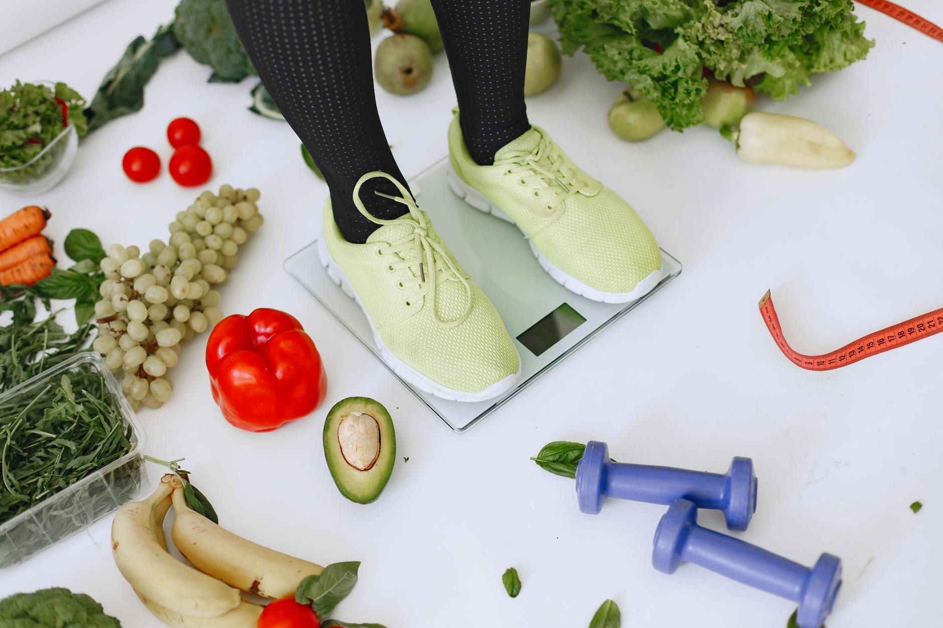 Person standing on scales surrounded by fresh produce and fitness equipment symbolizing a balanced lifestyle. - boost metabolism naturally