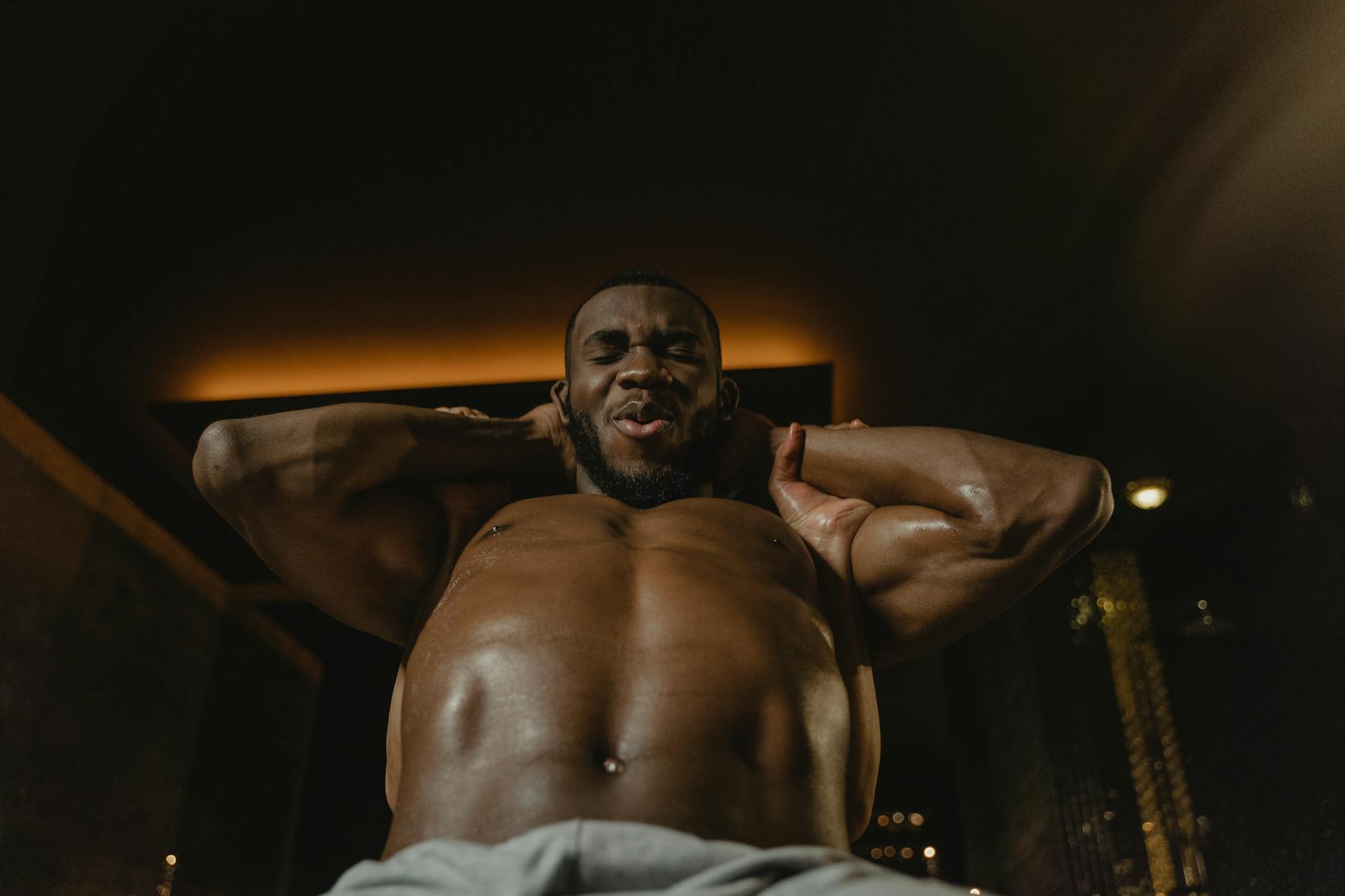 Muscular man working out indoors, showcasing strength and determination. - fat burning abs