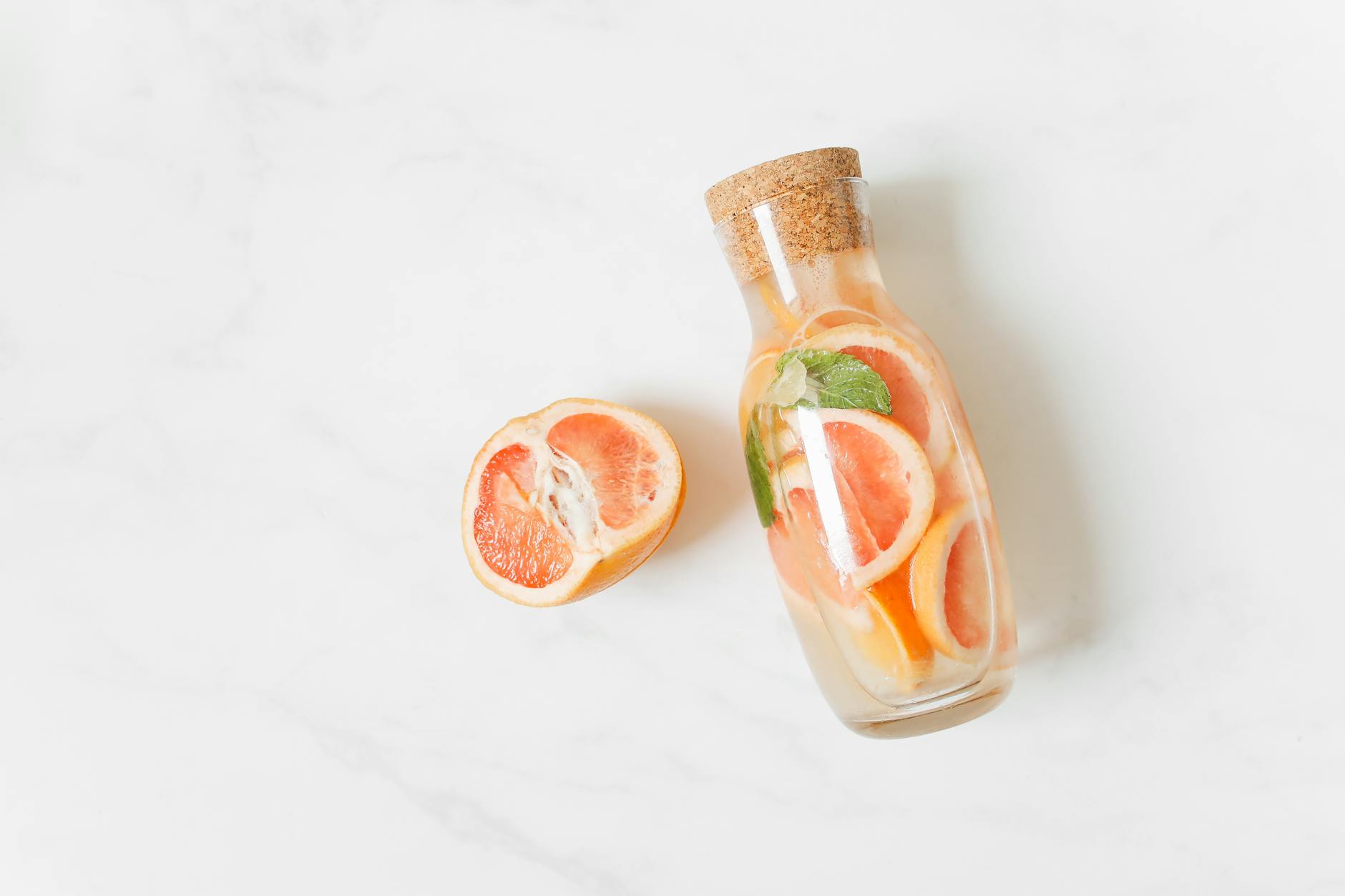Top view of a refreshing citrus infused water in a glass jar, perfect for a healthy drink. - gentle spring detox