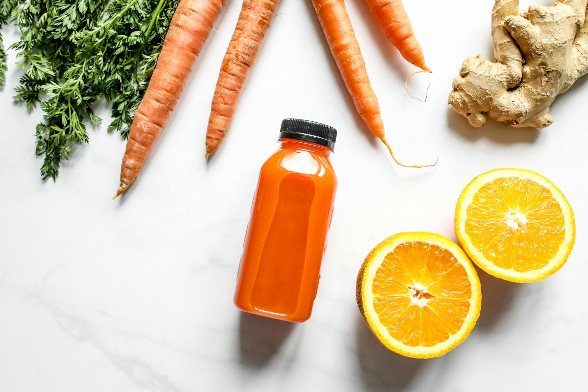 Vibrant carrot and orange juice with ginger, perfect for a nutritious start to the day. - gentle spring detox