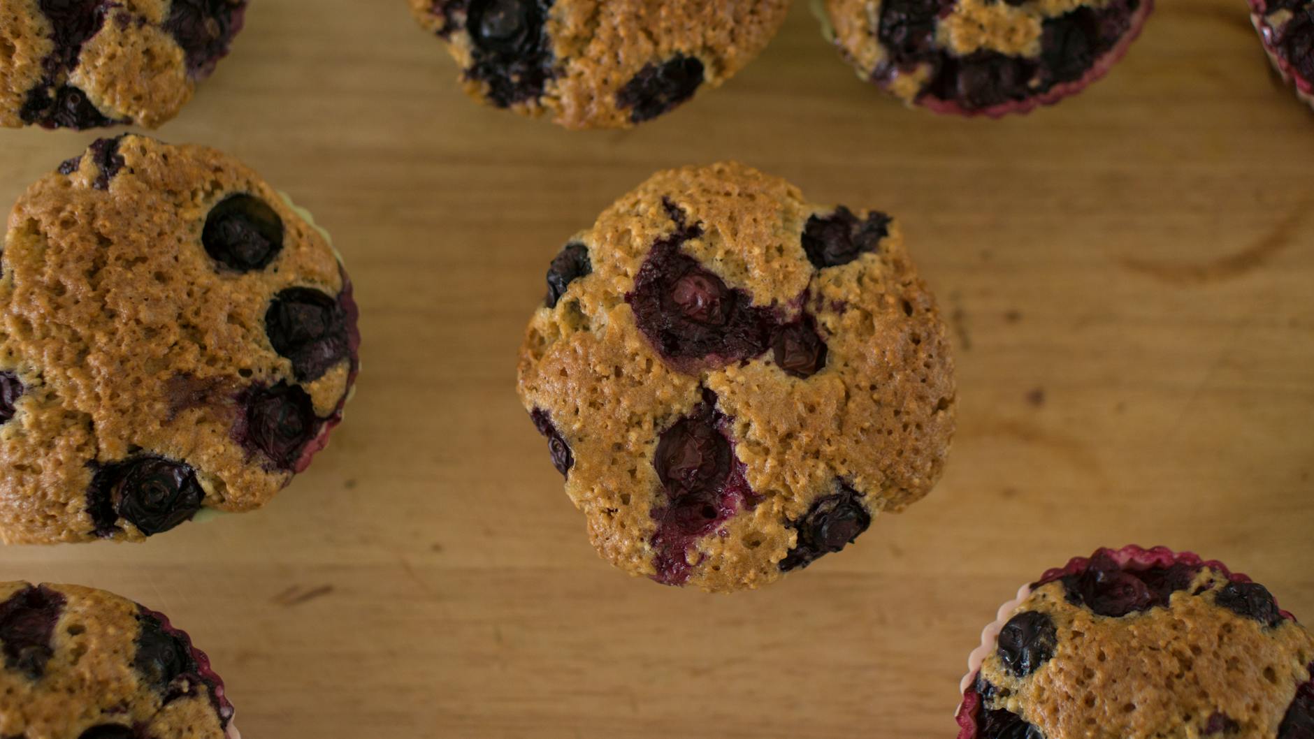 Delicious homemade blueberry muffins on a wooden table, perfect for breakfast or dessert. - healthy breakfast muffins