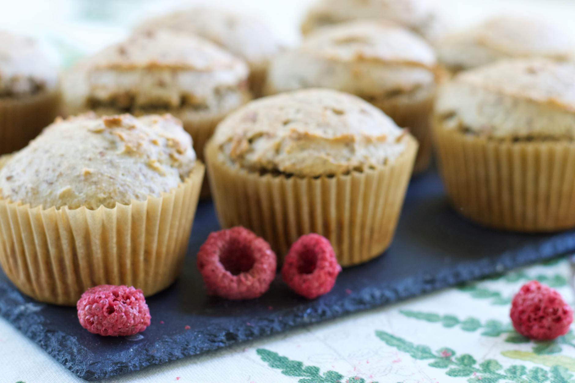 Delicious homemade muffins adorned with fresh raspberries on a slate plate. Perfect for a sweet breakfast treat. - healthy breakfast muffins