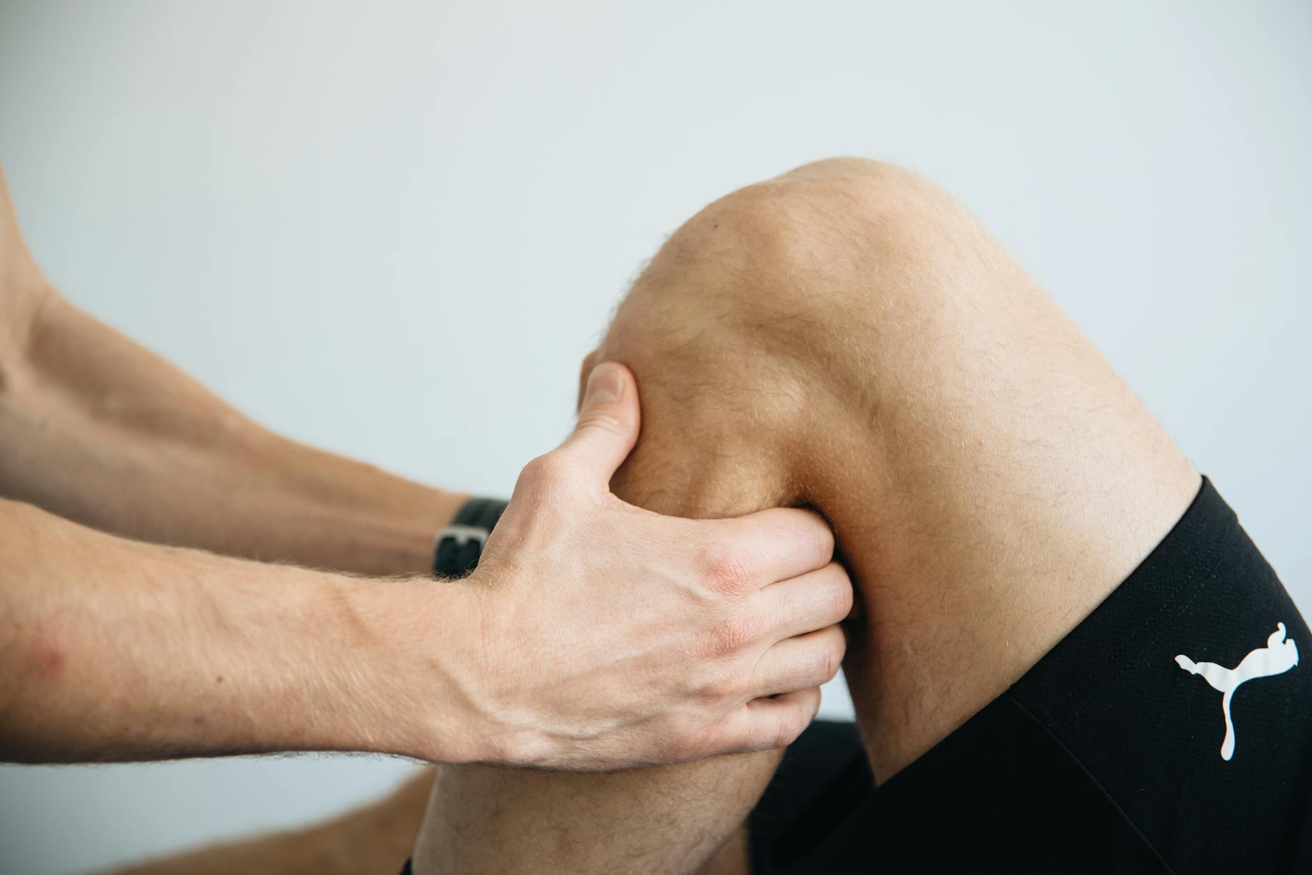 Detailed image of a physiotherapy session focusing on knee massage treatment. - knee pain relief exercises