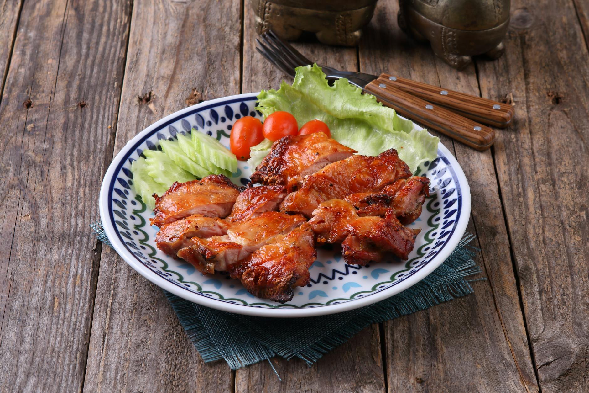 Juicy grilled chicken on a rustic plate with fresh vegetables for a hearty meal. - low carb chicken