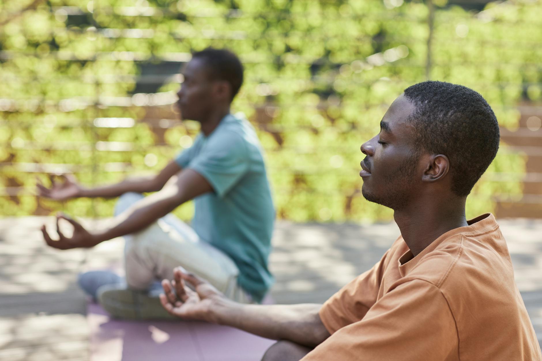 Two men meditating outdoors, capturing a sense of relaxation and mindfulness. - what is mindfulness