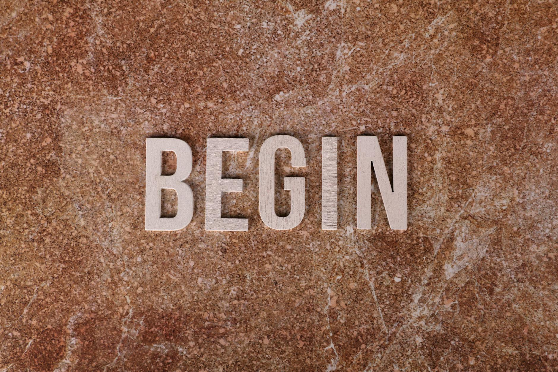 Text 'BEGIN' on a textured stone background, symbolizing a fresh start. - mindfulness for fresh start