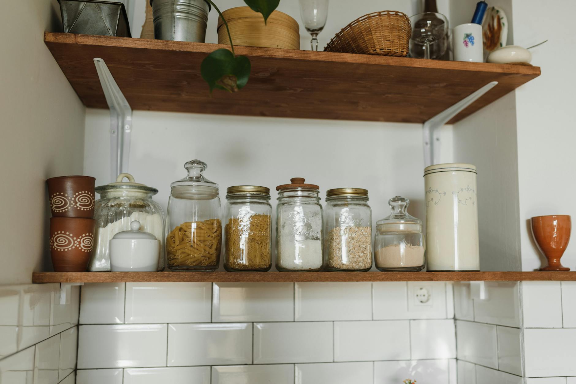 Aesthetic kitchen shelves displaying various jars and containers for organized storage. - pantry cleanout weight loss