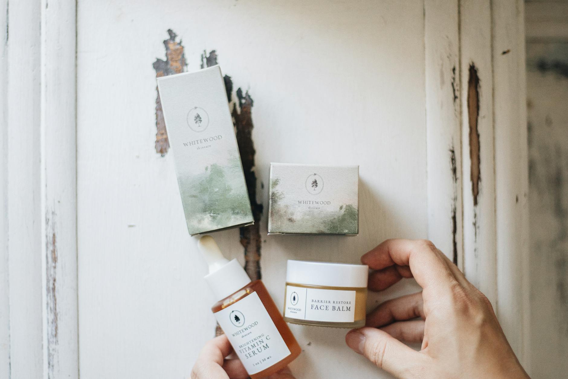 High-angle view of natural skincare products featuring face serum and balm with eco-friendly packaging. - spring skincare routine