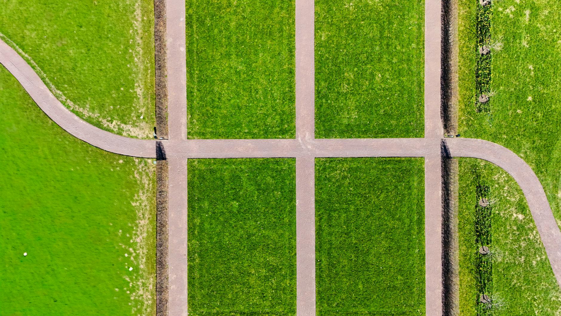 Aerial shot of a geometric pathway intersection in a vibrant park in Jönköping. - spring walking plan