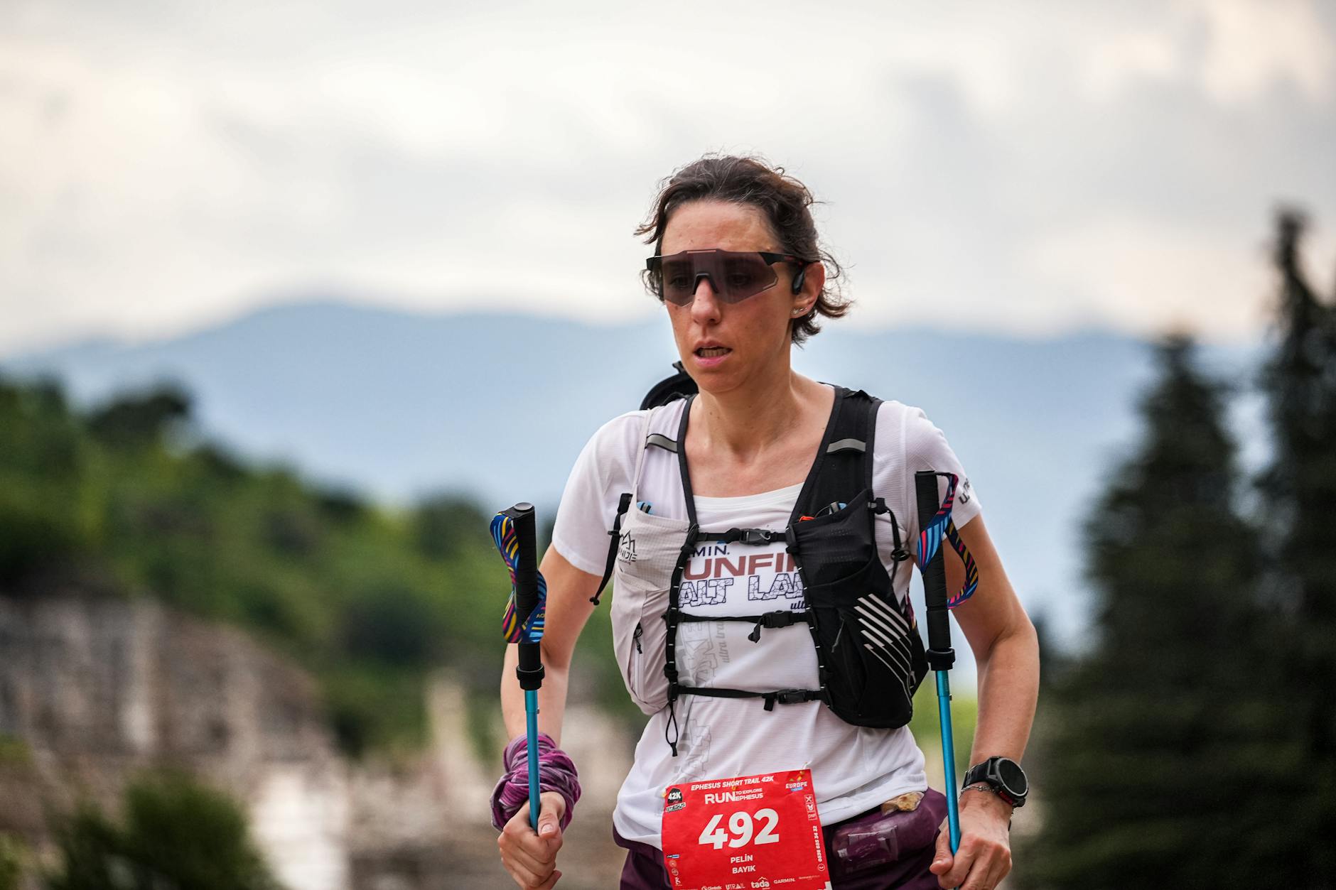 Female trail runner participating in an outdoor race, showcasing athletic determination. - trail running advanced