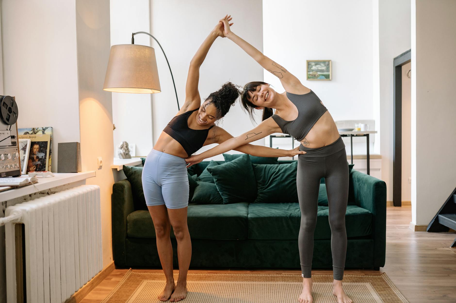 Two women practicing yoga in a modern living room, enjoying a healthy lifestyle. - balance exercise social life