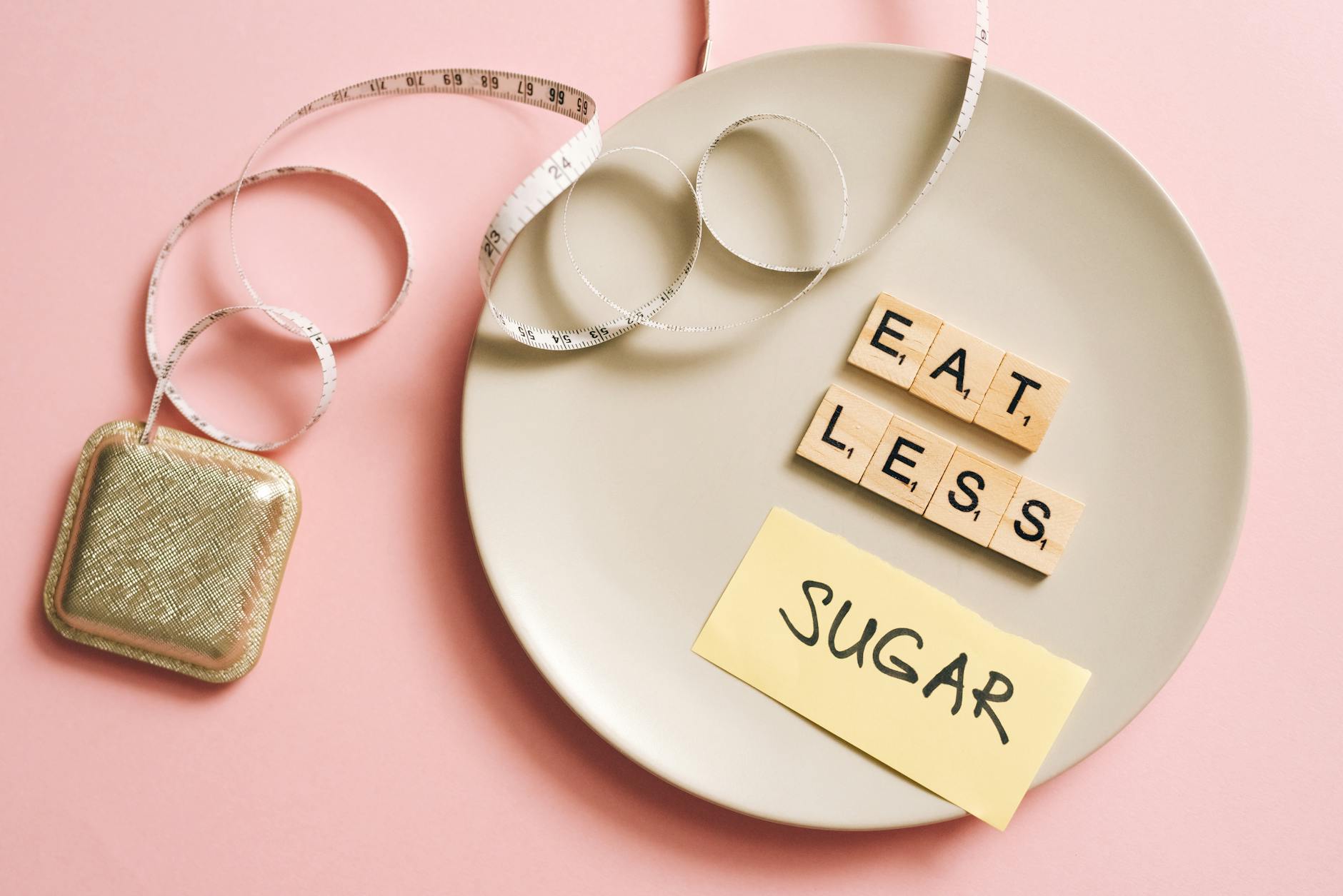 A conceptual image featuring a plate with messages made from Scrabble tiles and a tape measure, promoting healthy eating. - boost metabolism fat loss