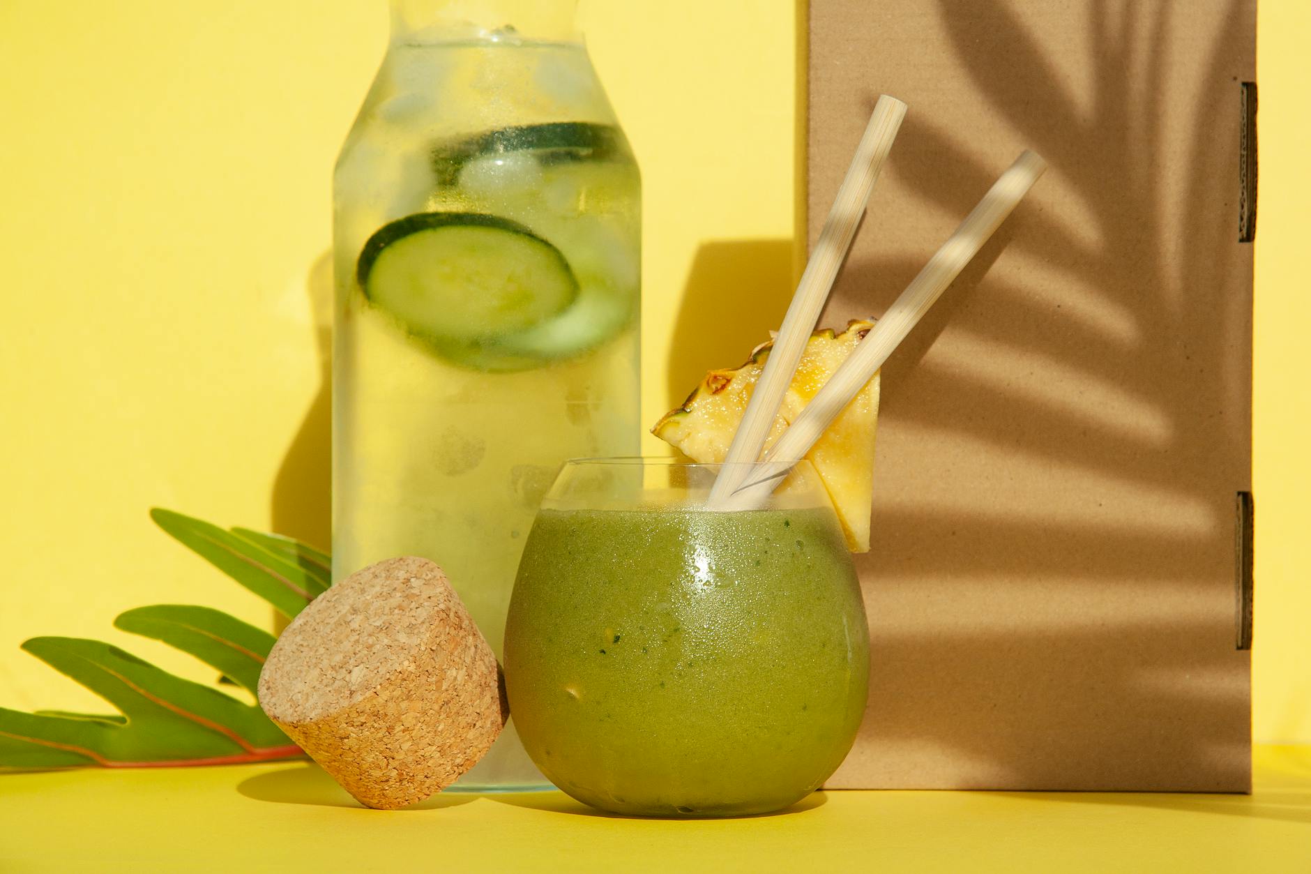 Delicious green smoothie with pineapple and cucumber water against a yellow backdrop. Perfect summer refreshment. - green smoothie benefits