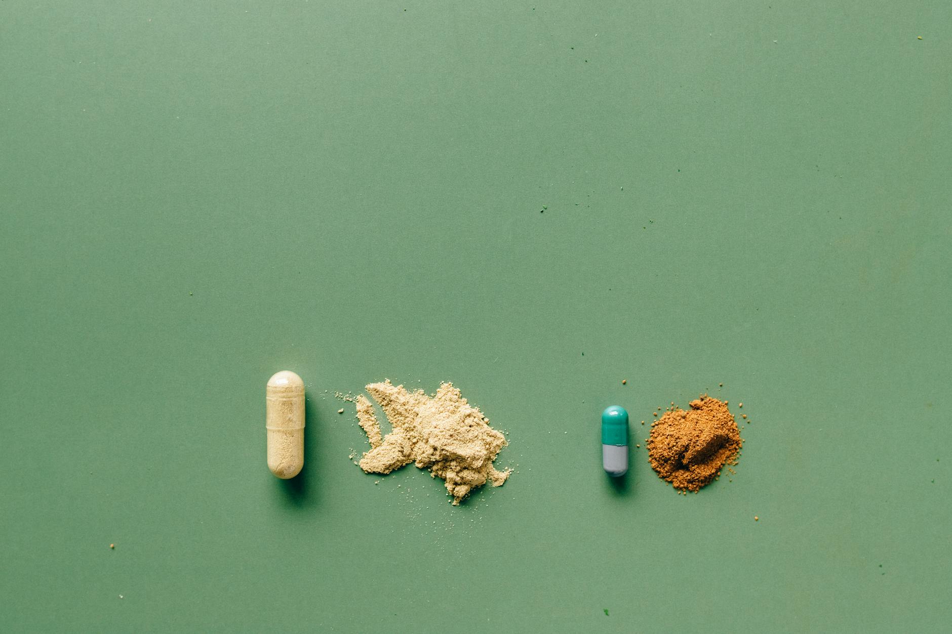 Variety of capsules and powders showcasing natural and pharmaceutical remedies on a green backdrop. - gut health allergies