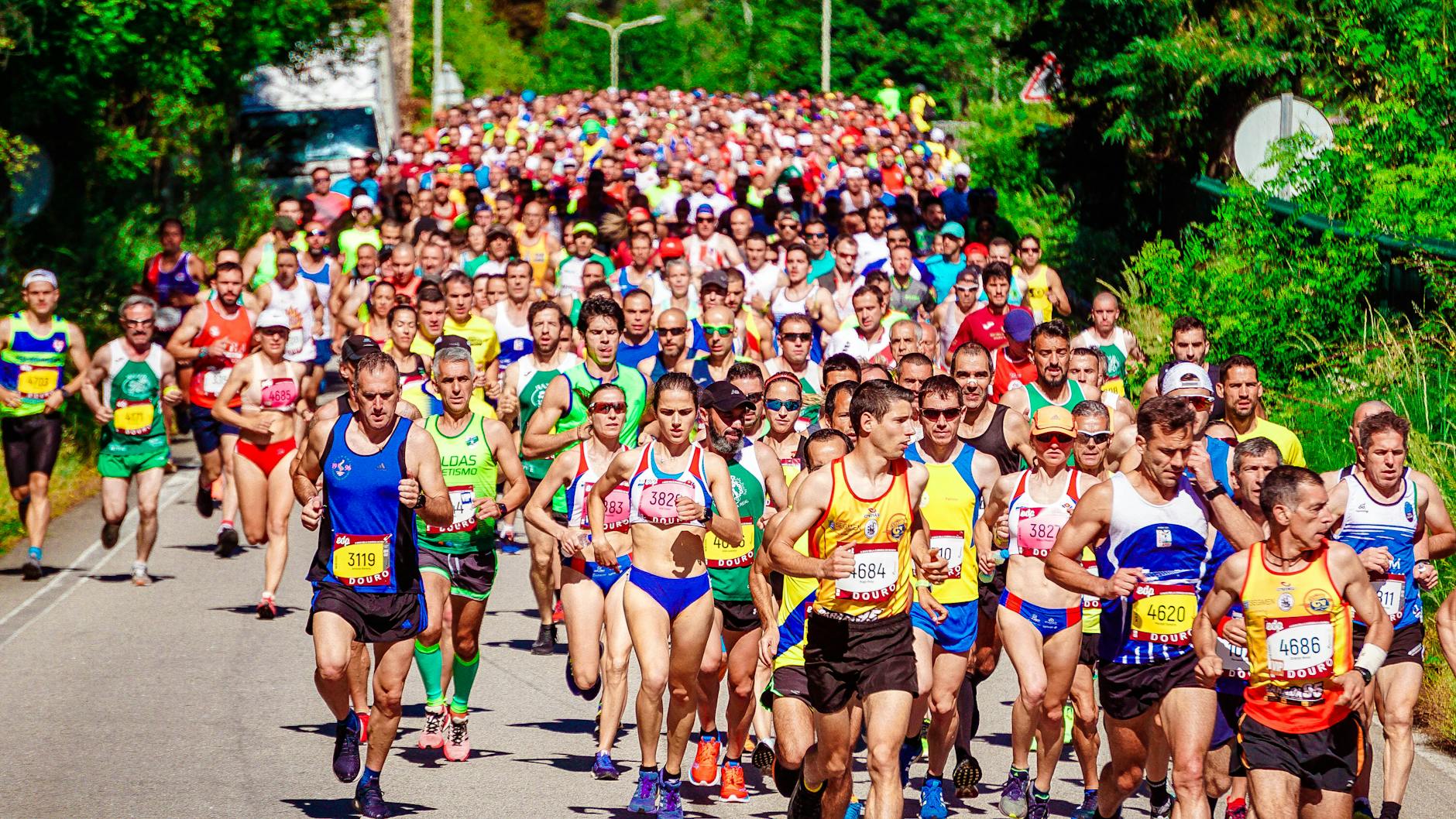 Energetic marathon runners competing on a sunny day, showcasing perseverance and community spirit. - marathon recovery nutrition