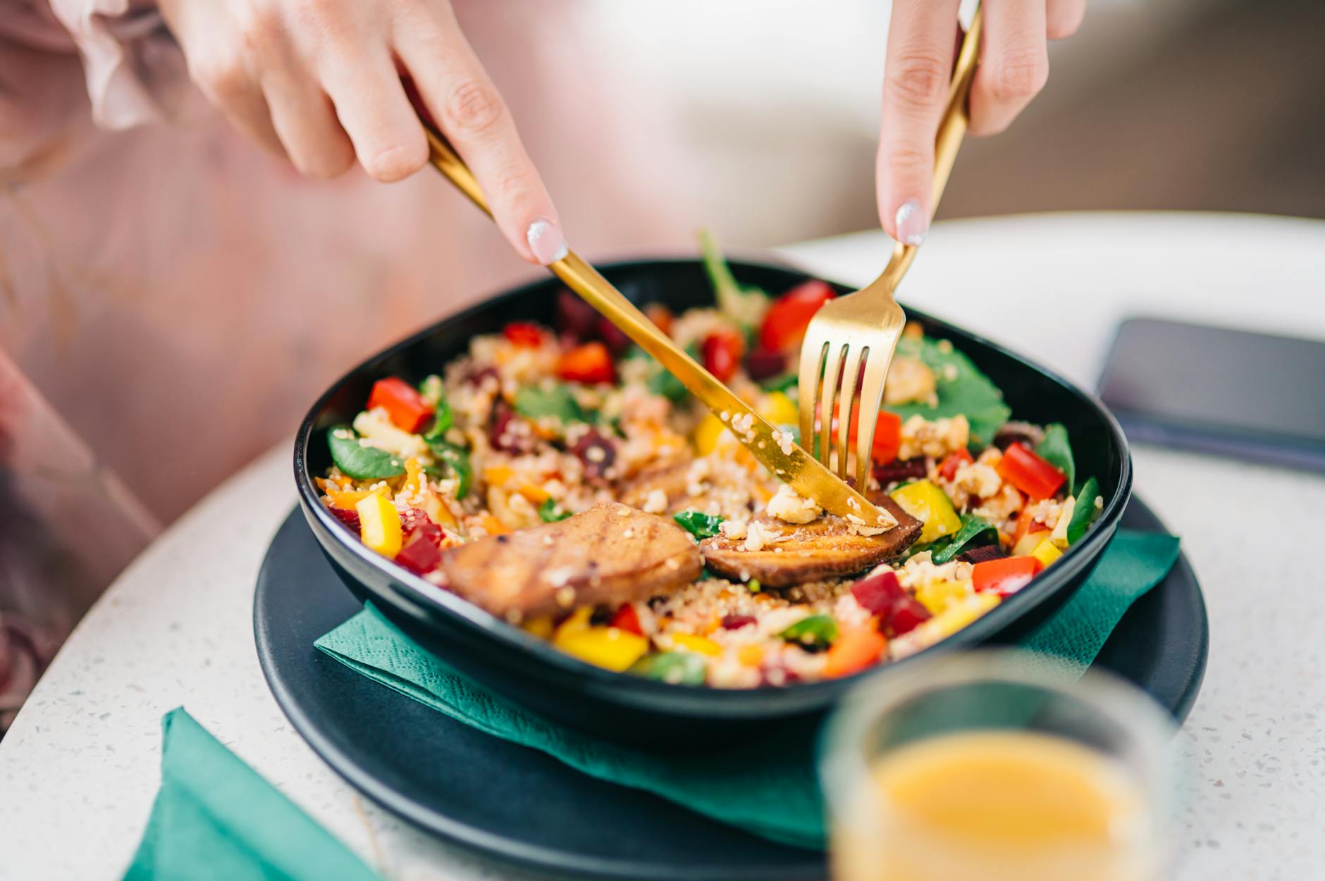 Vibrant quinoa salad with fresh veggies being enjoyed by a diner. - mindful eating may