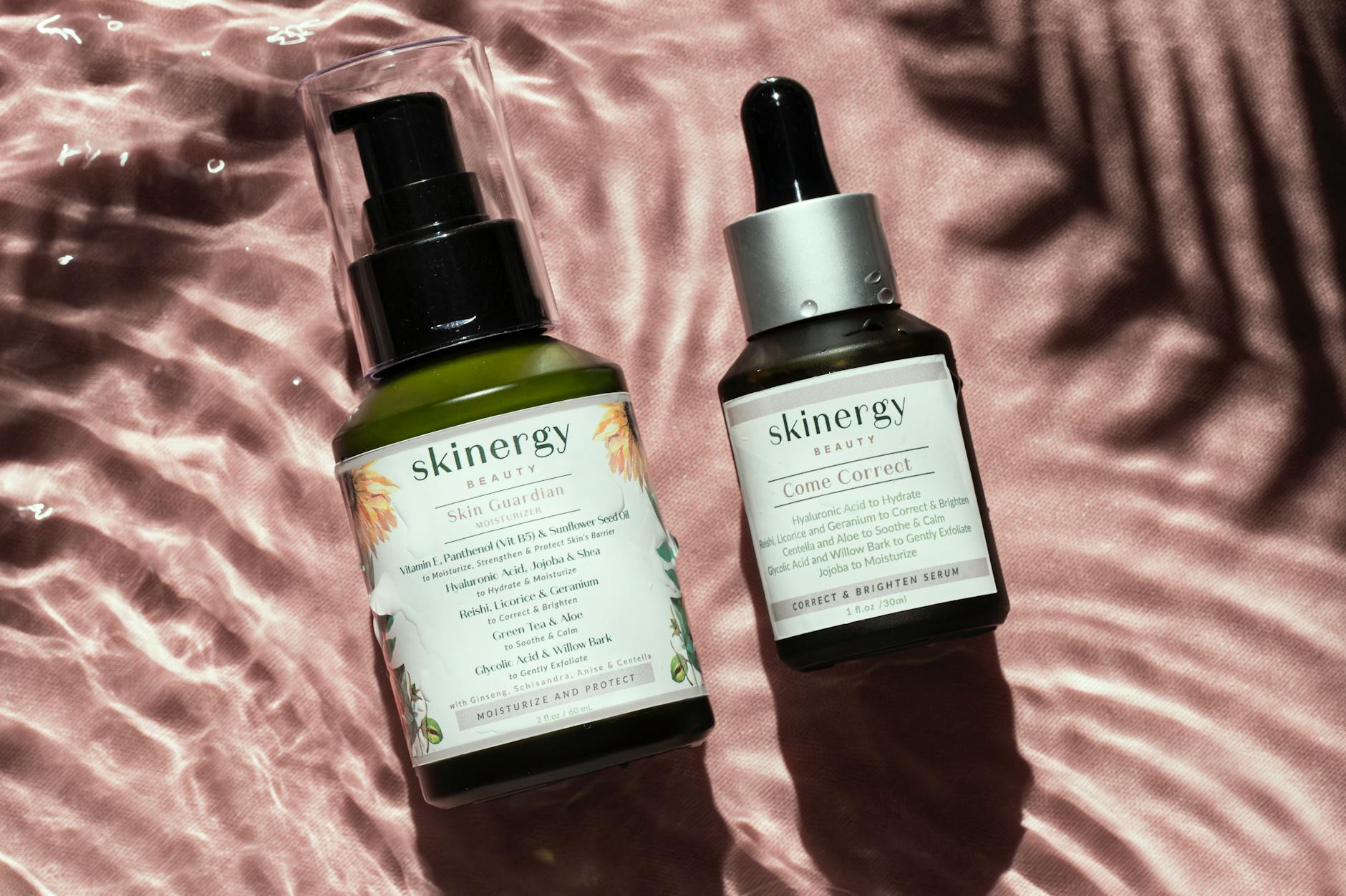 Close-up of luxury skincare bottles on a satin surface with water reflections. - nourish skin from within
