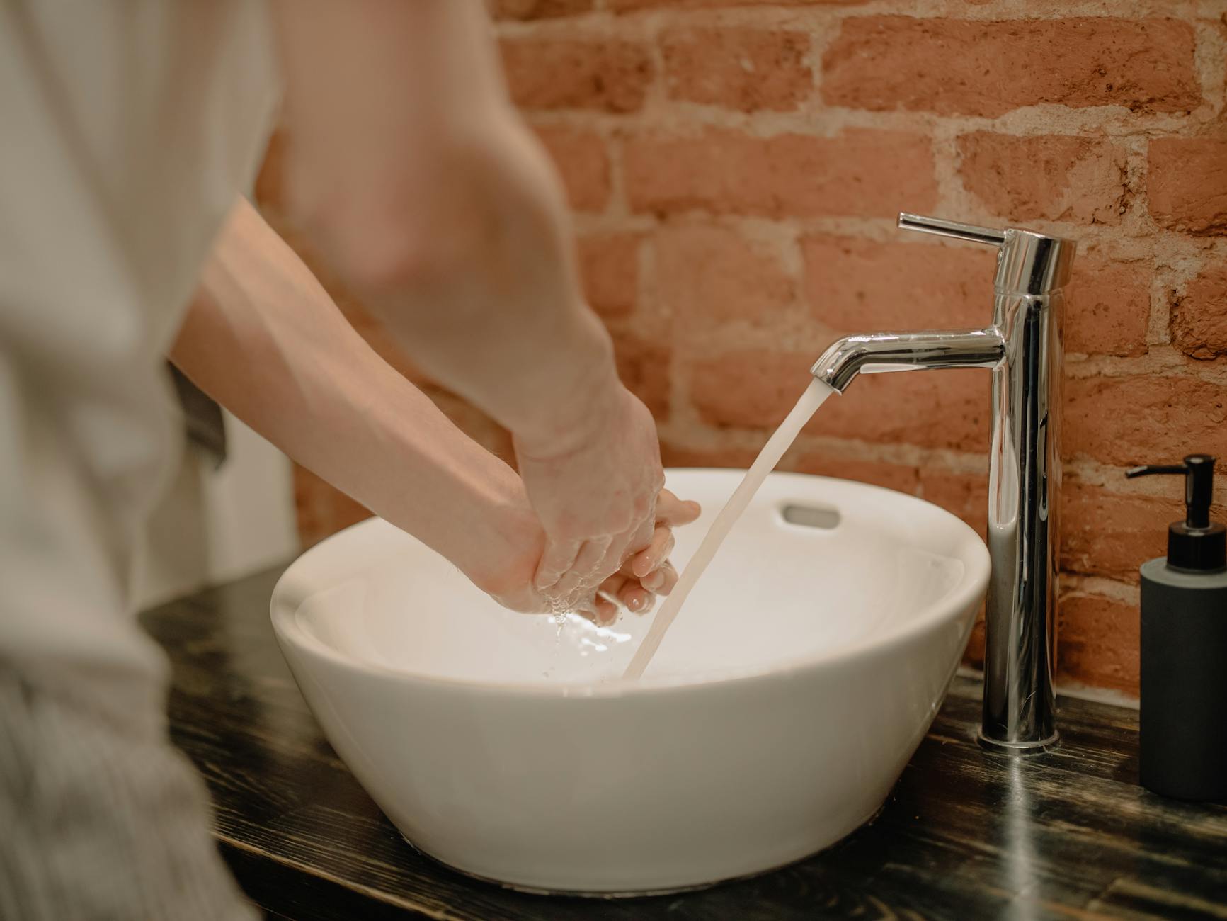 Close-up of hand washing with soap in a stylish bathroom. Vital hygiene practice. - personal hygiene tips
