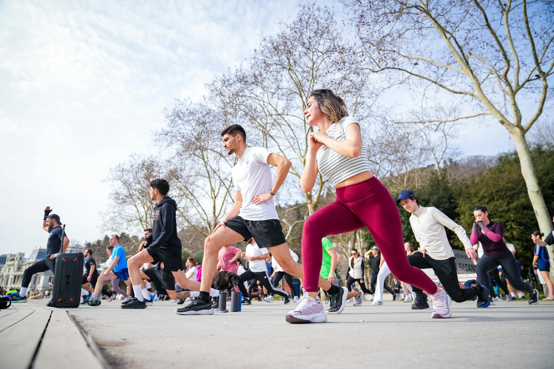 Group of adults in a fitness class outdoors in İstiklal Park, İstanbul. - spring exercise daylight