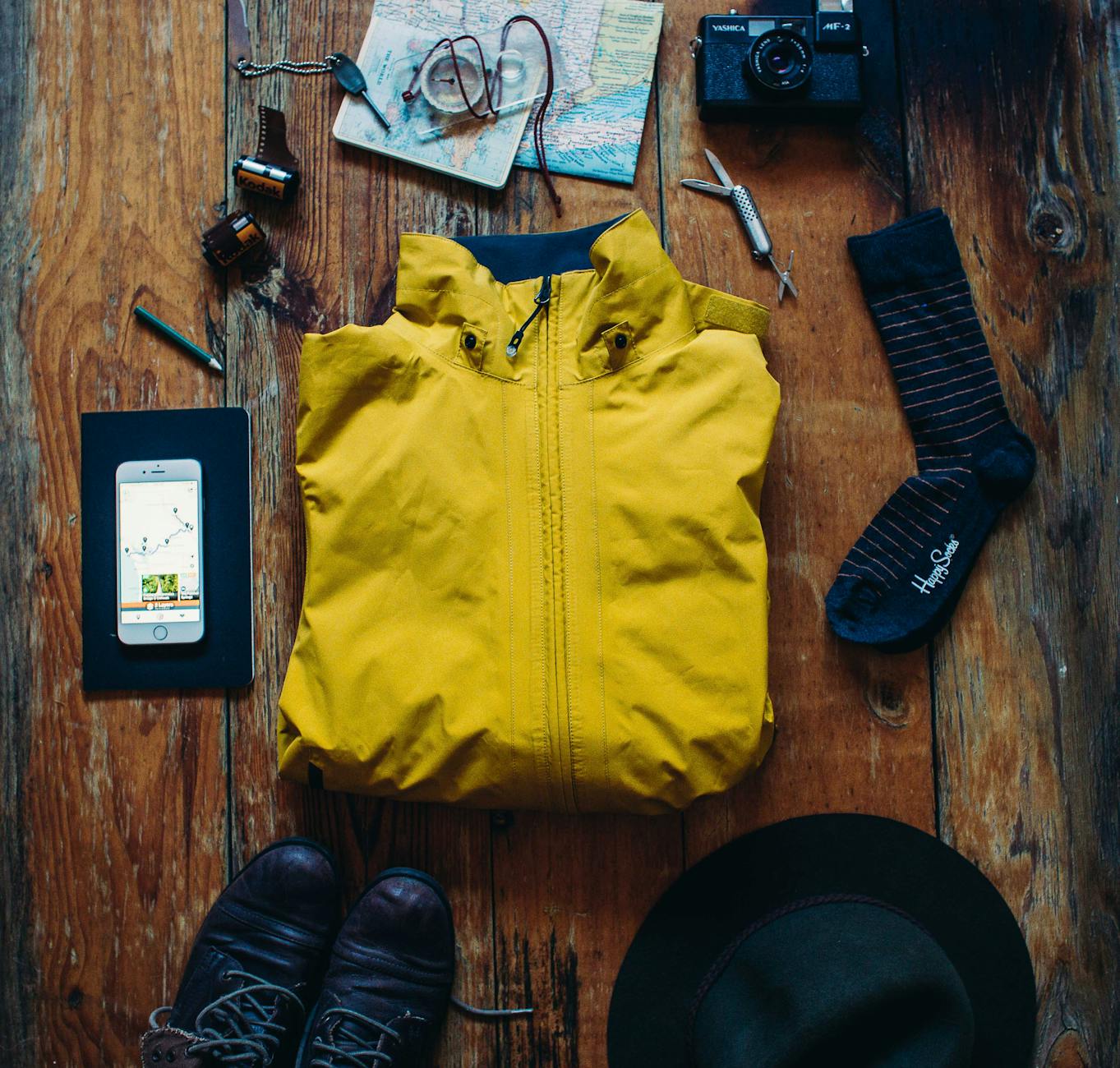 Exploration essentials: boots, map, camera, jacket for your next adventure. - spring hiking essentials