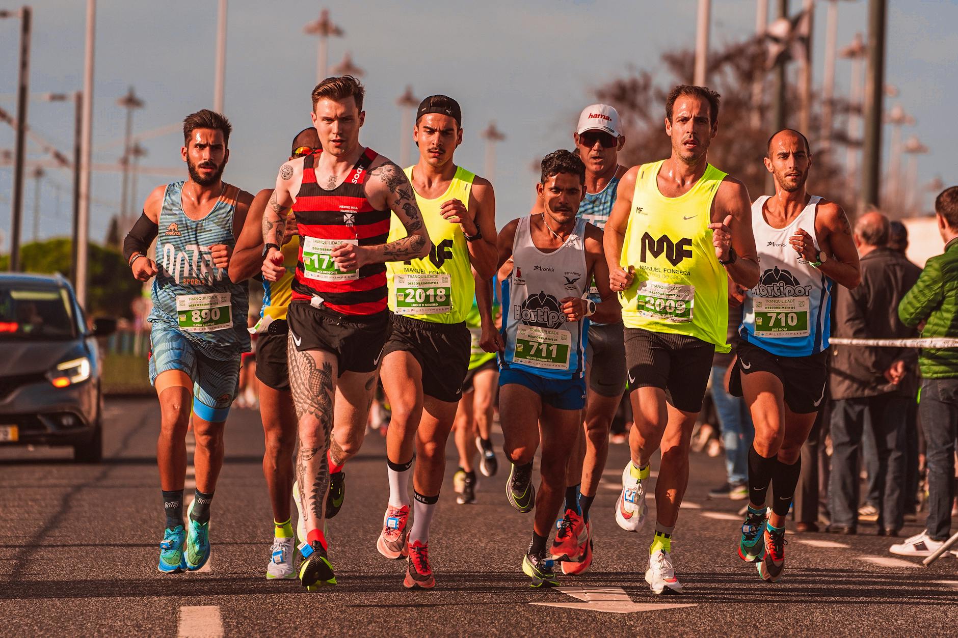 A diverse group of male runners competing in an outdoor marathon race, showcasing athletic endurance and team spirit. - spring marathon training