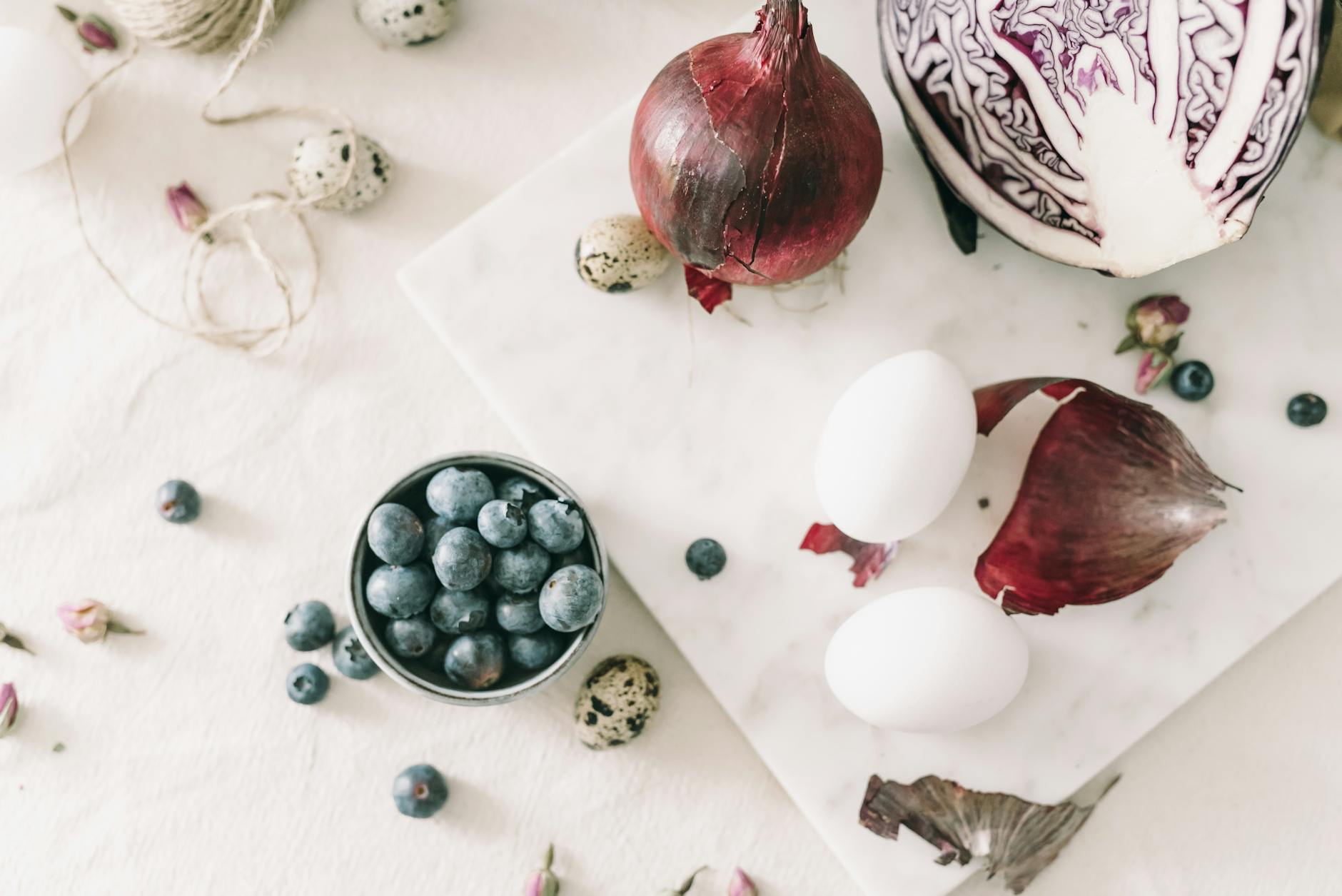 Explore natural egg dyeing with red cabbage, blueberries, and onions for a unique Easter decoration. - spring mood foods