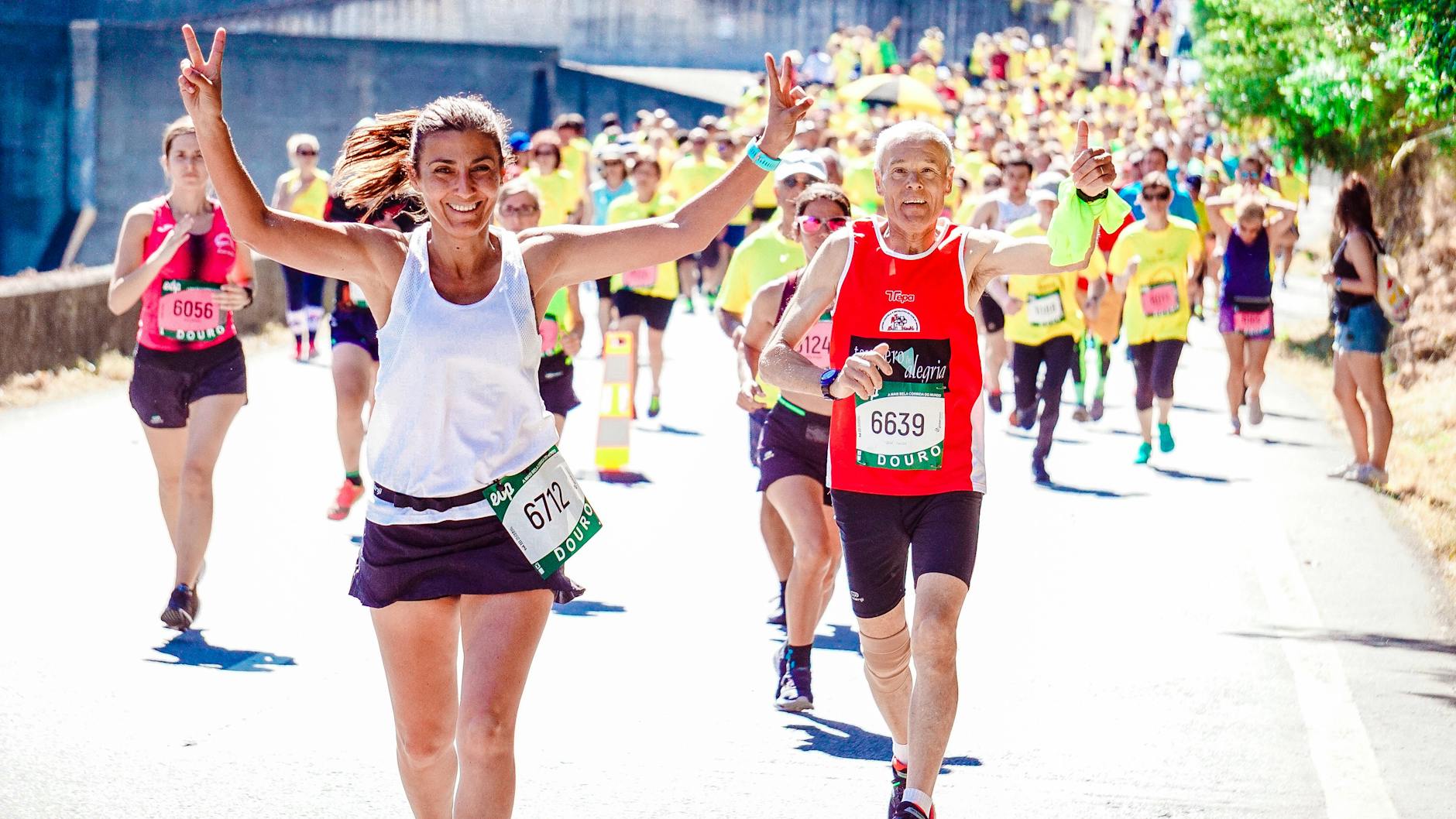 A group of diverse runners participating in a lively marathon event under the sun. - spring run nutrition