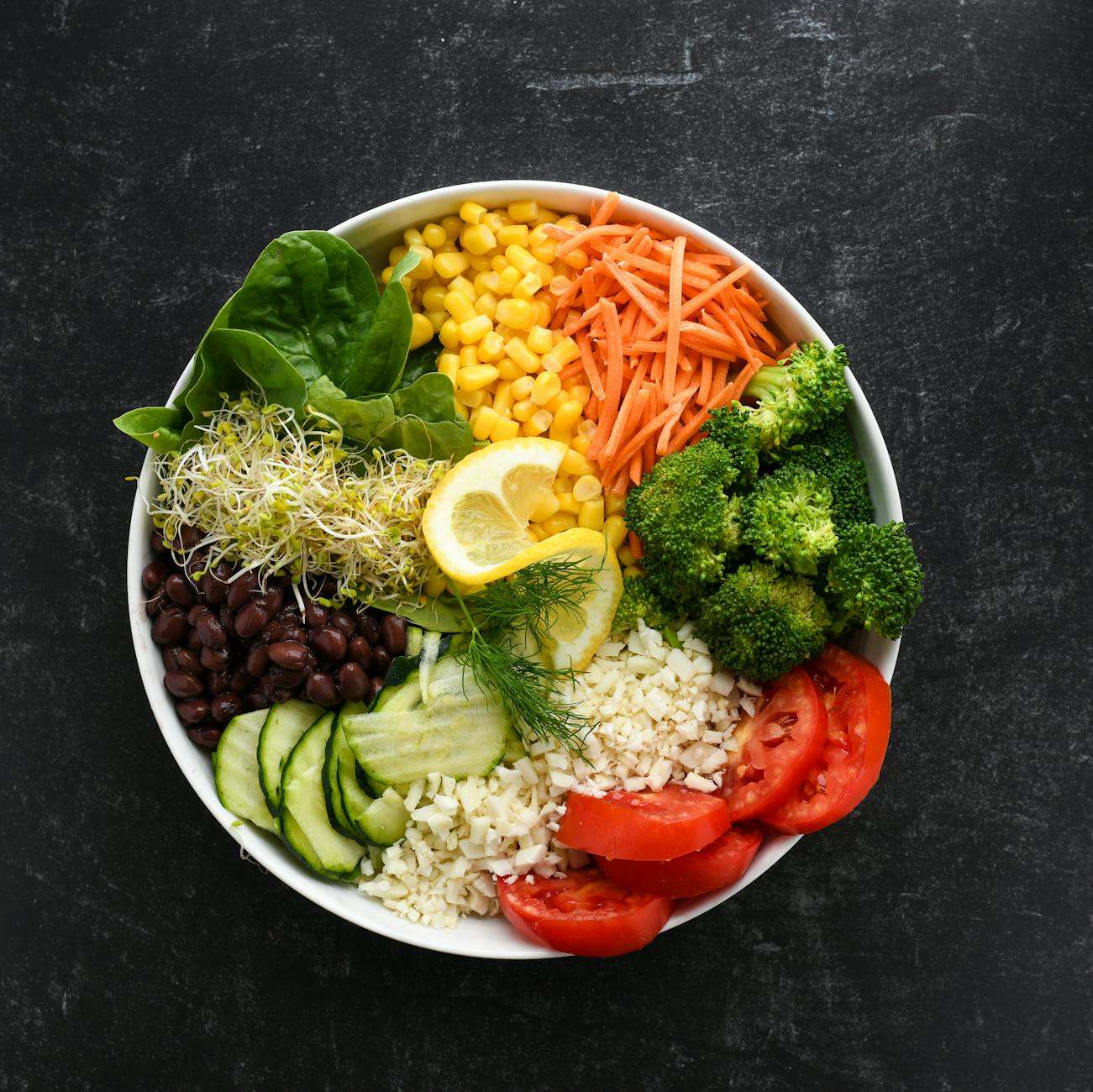 Top view of a vibrant salad bowl with fresh vegetables for a healthy meal. - spring veggie bowls