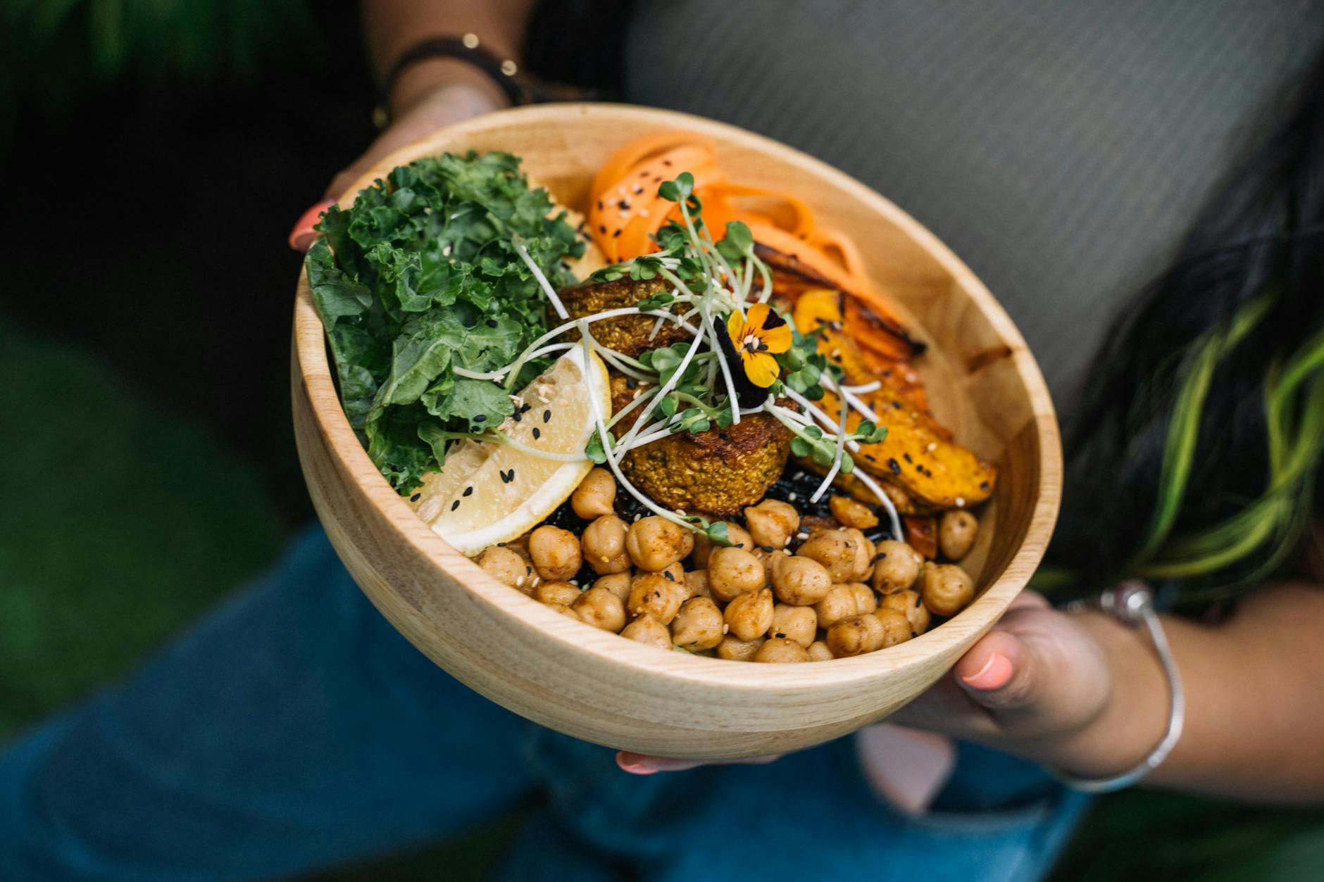 Healthy vegan bowl with chickpeas, kale, carrots, and lemon served fresh. - spring veggie bowls