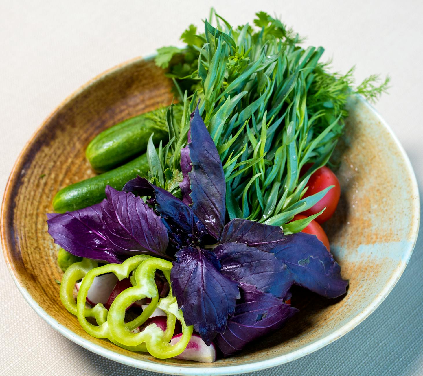 Colorful assortment of fresh vegetables in a ceramic bowl, perfect for healthy eating. - spring veggie bowls