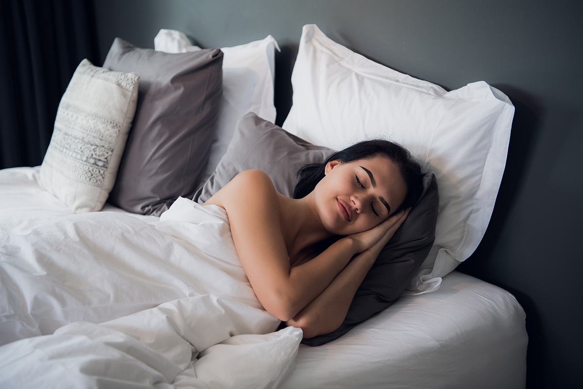 Woman enjoying better sleep quality thanks to regular exercise