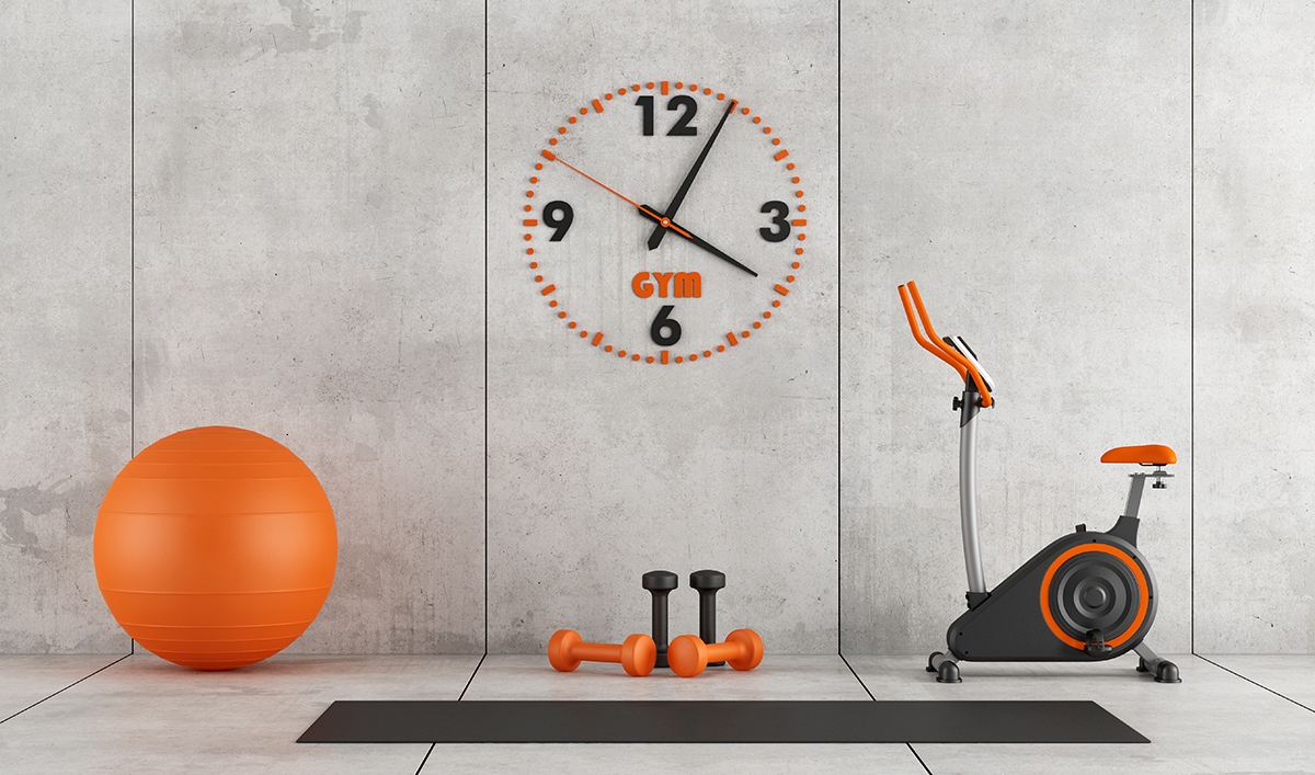 Clock and gym equipment showcasing the importance of knowing gym opening times