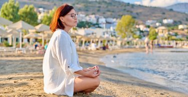 Person meditating in a tranquil environment for stress management