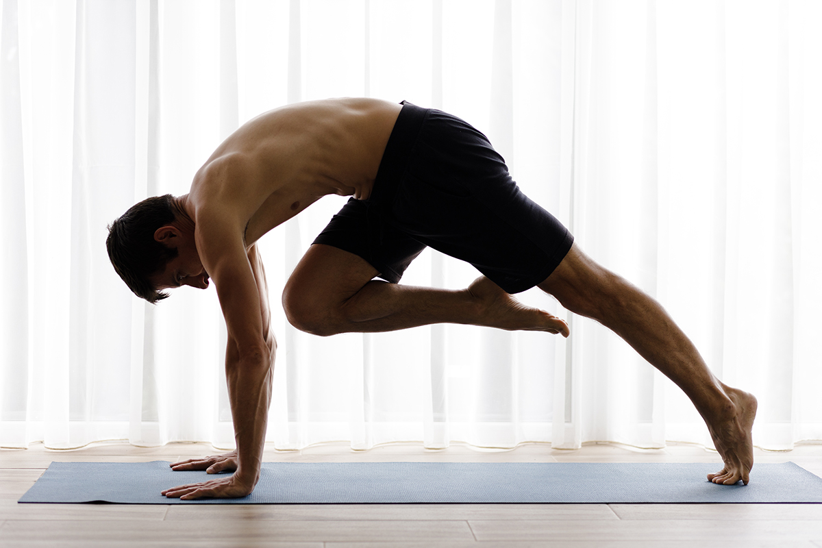 Man exhibiting yoga benefits with a strength-building pose