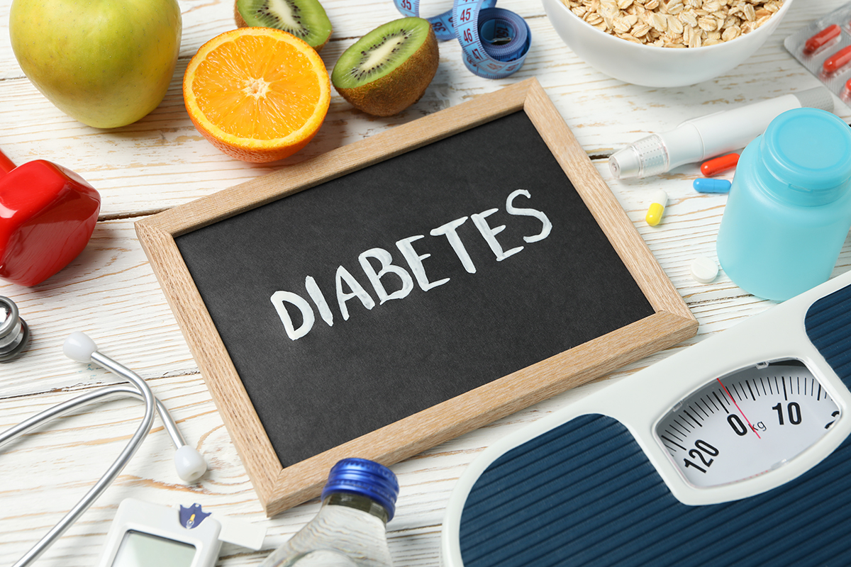 Word 'Diabetes' with diabetic accessories on wooden background