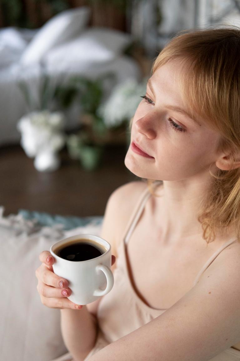 Person enjoying a cup of black coffee for weight loss